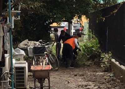 Photo 1. Shoveling out soil after flood